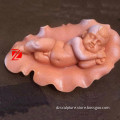 stone sleeping baby sculpture with lotus leaf